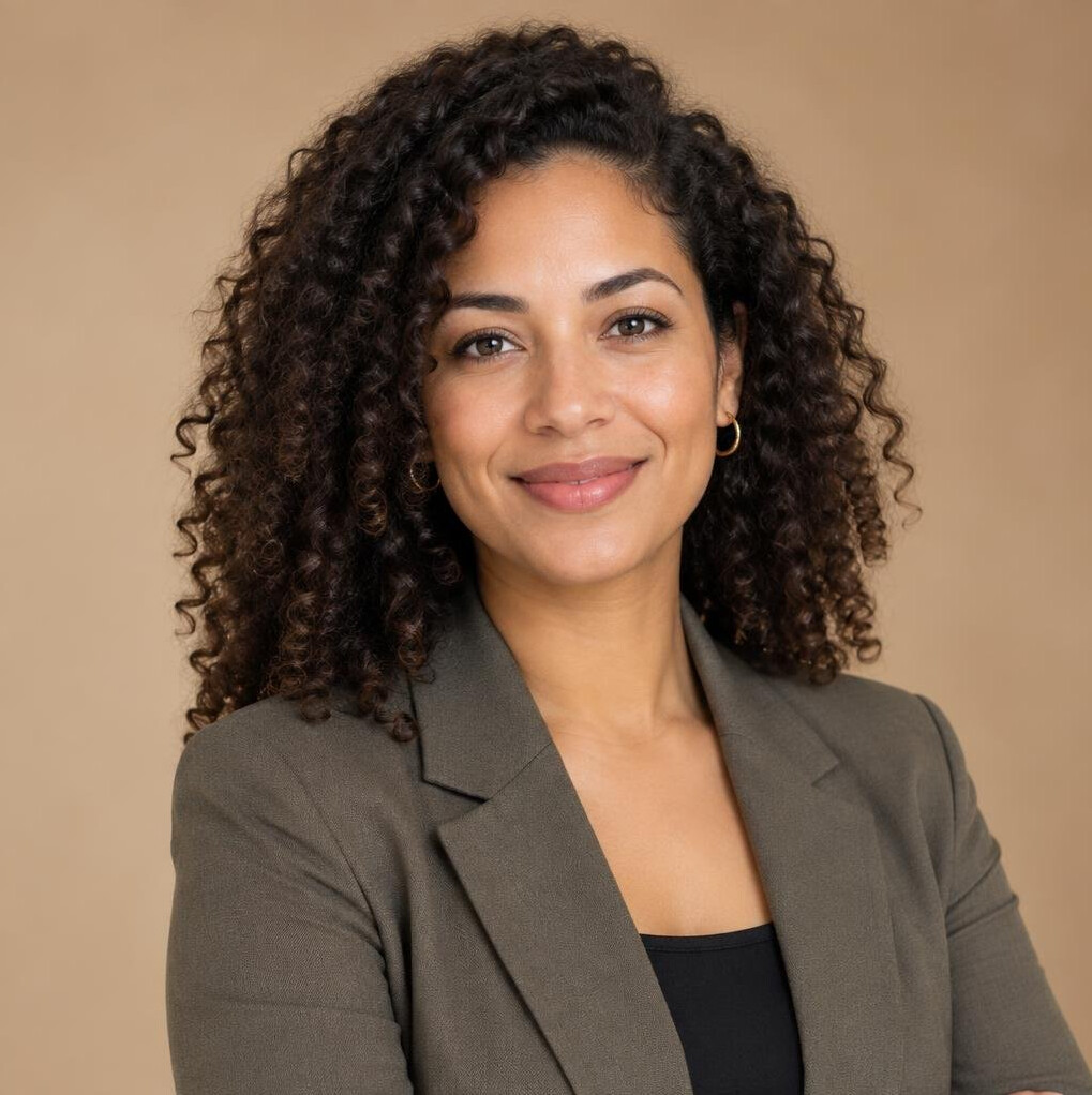 Studio portrait of a young woman with curly hair in a blazer