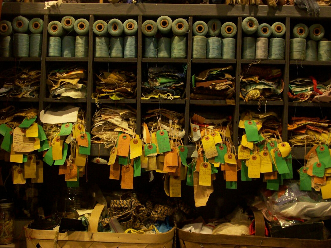 Archive shelves filled with film reels and labeled broadcast tapes